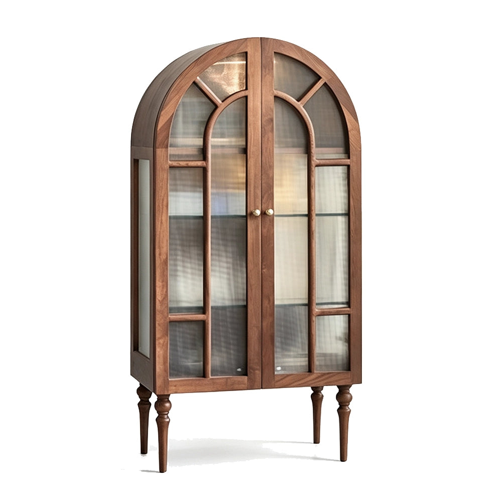 Brown arched glass display cabinet with double doors and turned legs on a white background.