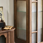 Detail of the brown cabinet's textured glass side panel and interior shelf.