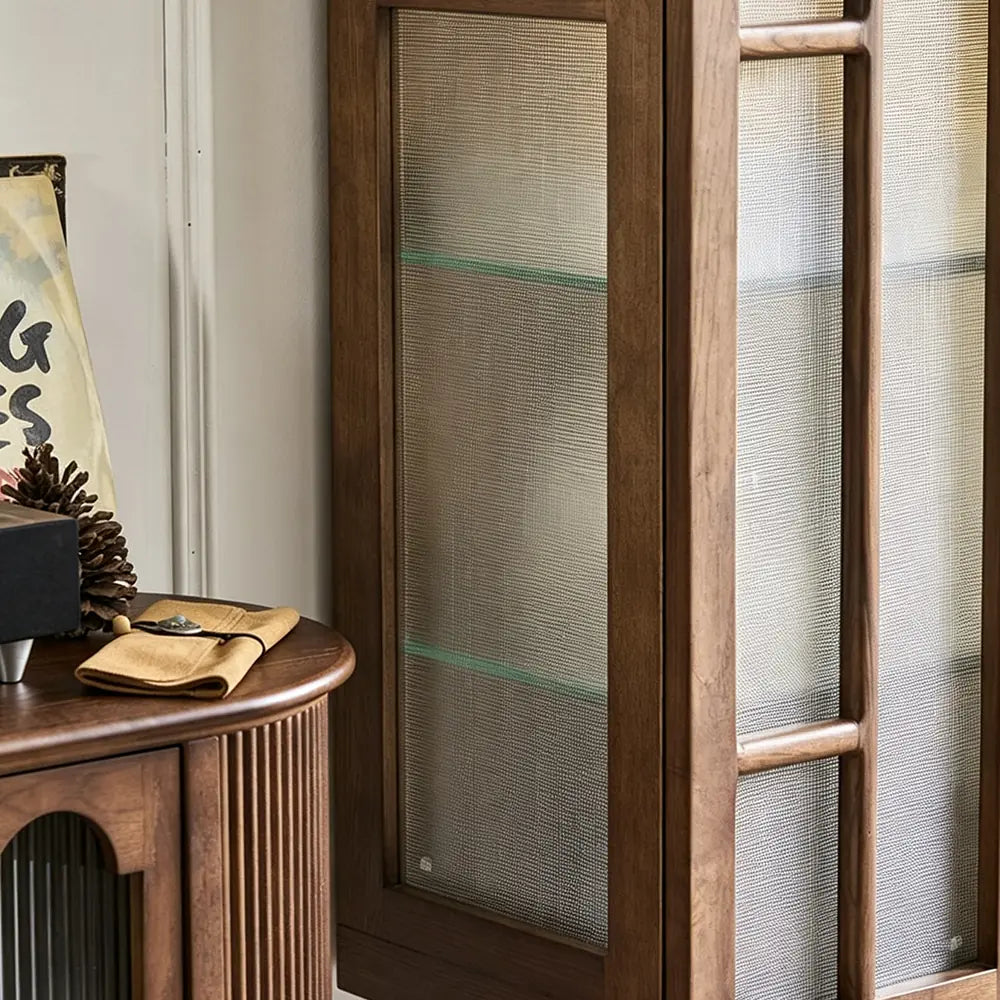 Detail of the brown cabinet's textured glass side panel and interior shelf.