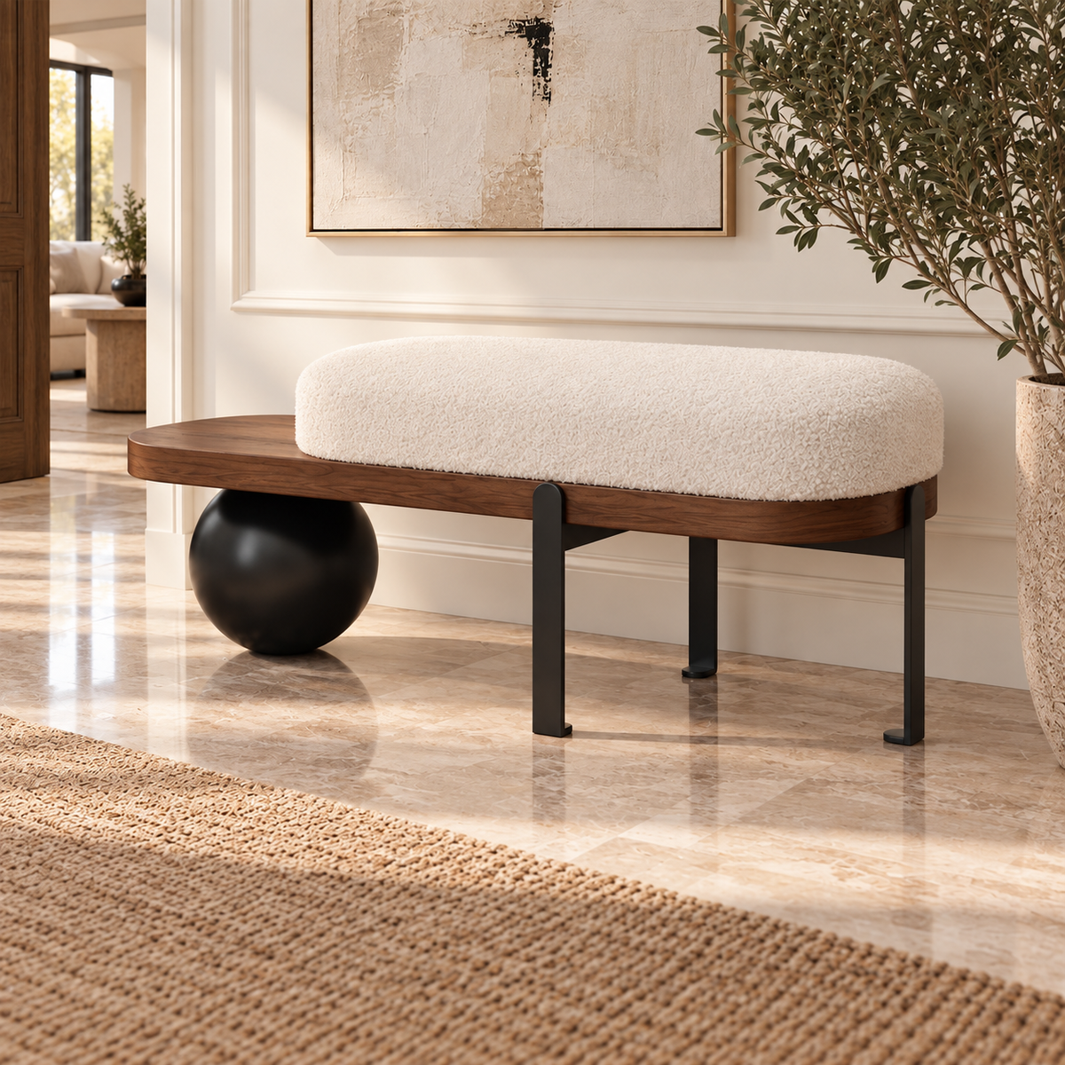 Cream upholstered entryway bench with a brown frame, exposed side shelf and black spherical support.