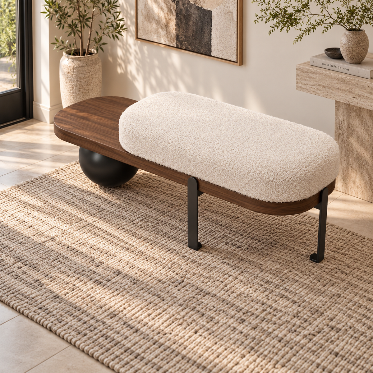 Angled overhead view of the cream cushion and brown side shelf on the ball-leg bench.