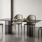 Rectangular black dining table with smoky transparent panel supports and beige upholstered chairs.