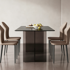 End view of the rectangular dark dining table and transparent support between upholstered chairs.