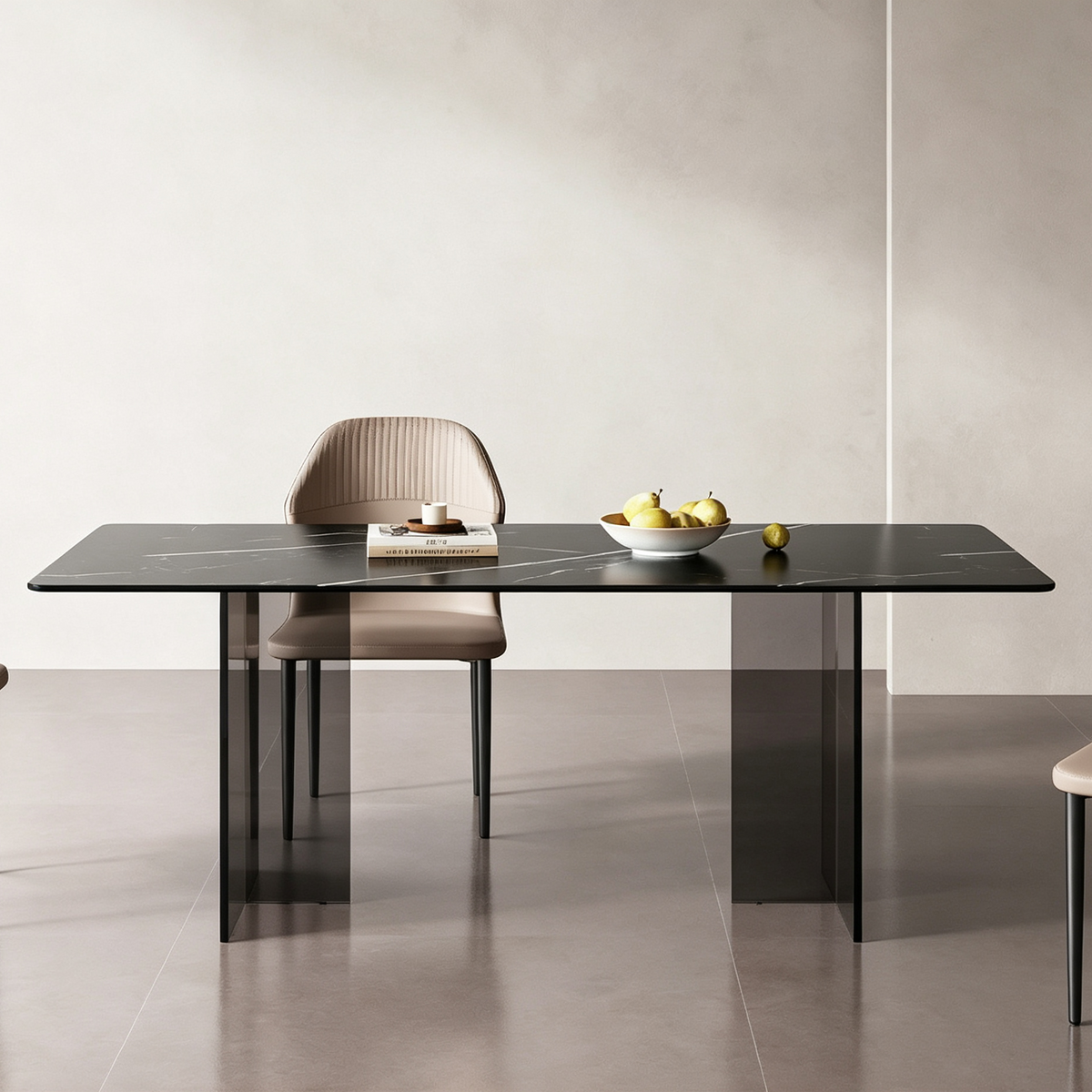 Front view of the dark rectangular dining table on transparent supports, styled with fruit and a cup.