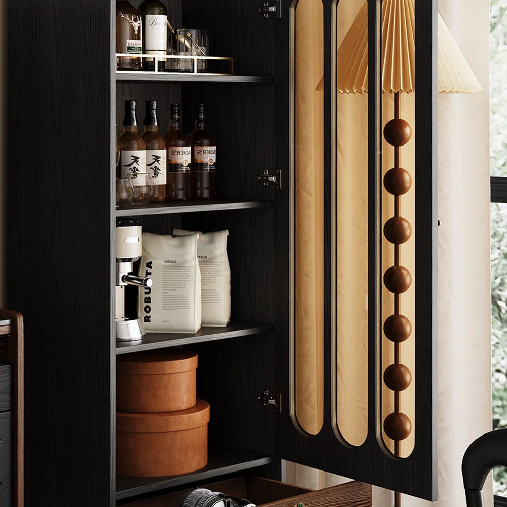 Black cabinet with its glass door open, revealing shelves of bottles, books and storage boxes.
