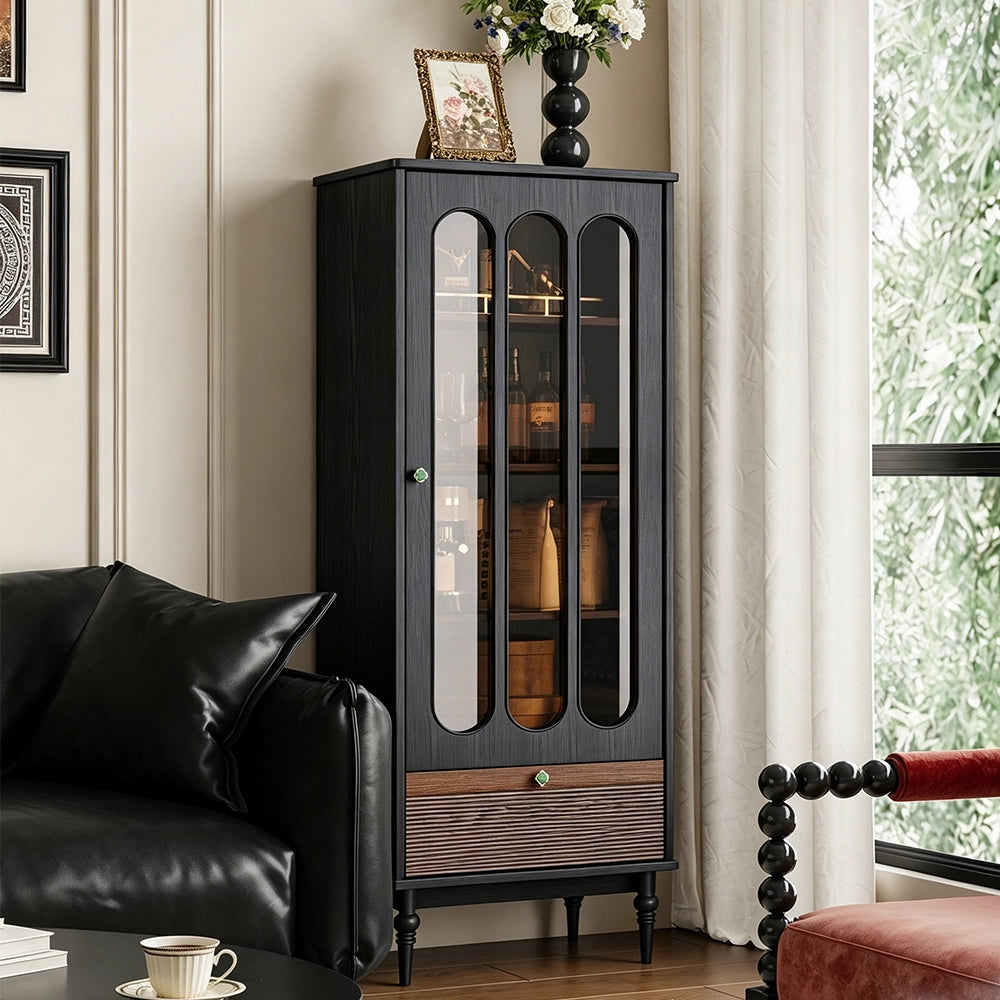 Front room view of the black glass display cabinet with green knobs and a brown textured drawer front.
