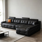 Black sectional sofa with square-tufted seats, padded headrests and a chaise on the right as pictured.