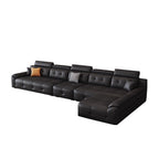 Wide black sectional sofa configuration with tufted seats, padded headrests and a right-side chaise.