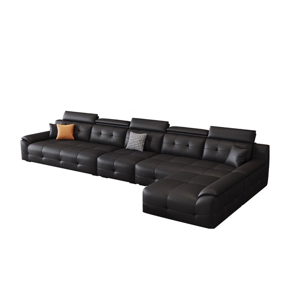 Wide black sectional sofa configuration with tufted seats, padded headrests and a right-side chaise.