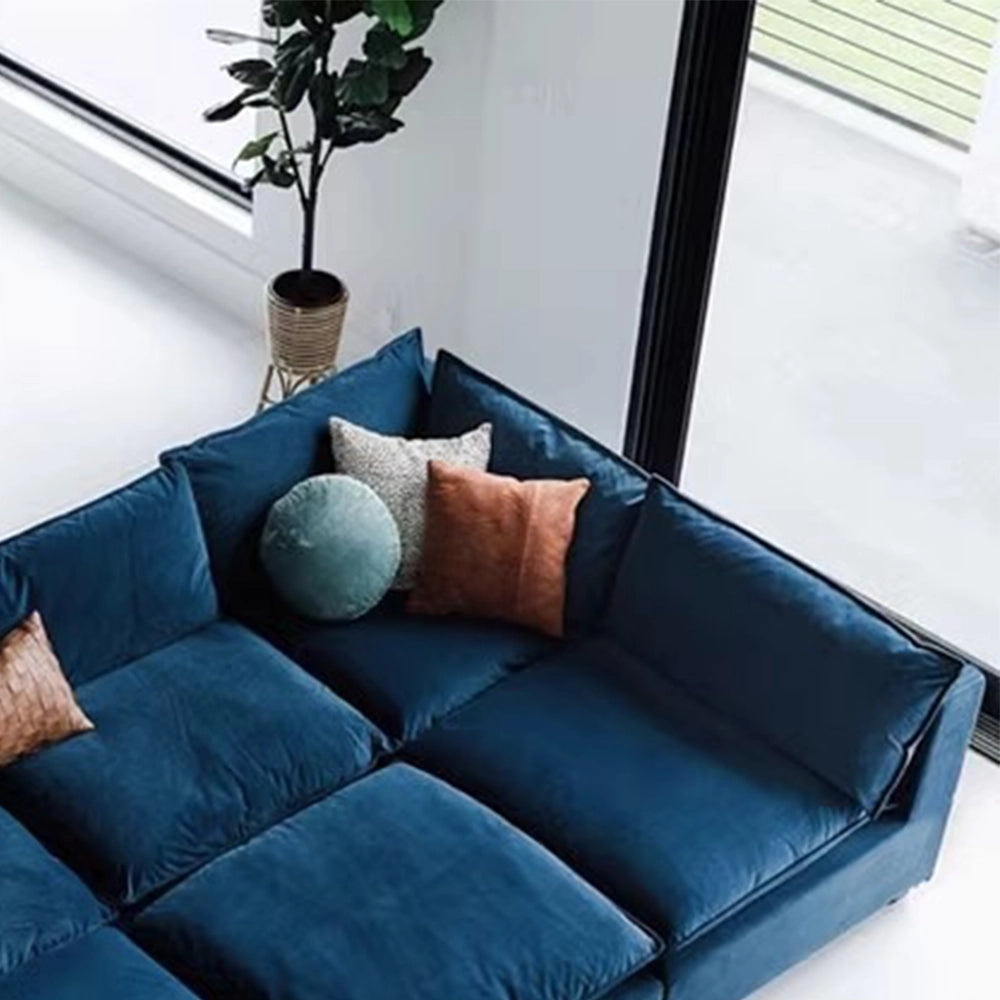Close-up of the blue modular sofa's right corner, side cushions and deep seat.