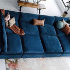 Overhead detail of the blue modular sofa's central seat cushions and accent pillows.