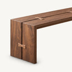 Detail of the bench's left slab support and butterfly-shaped accent across its center seam.