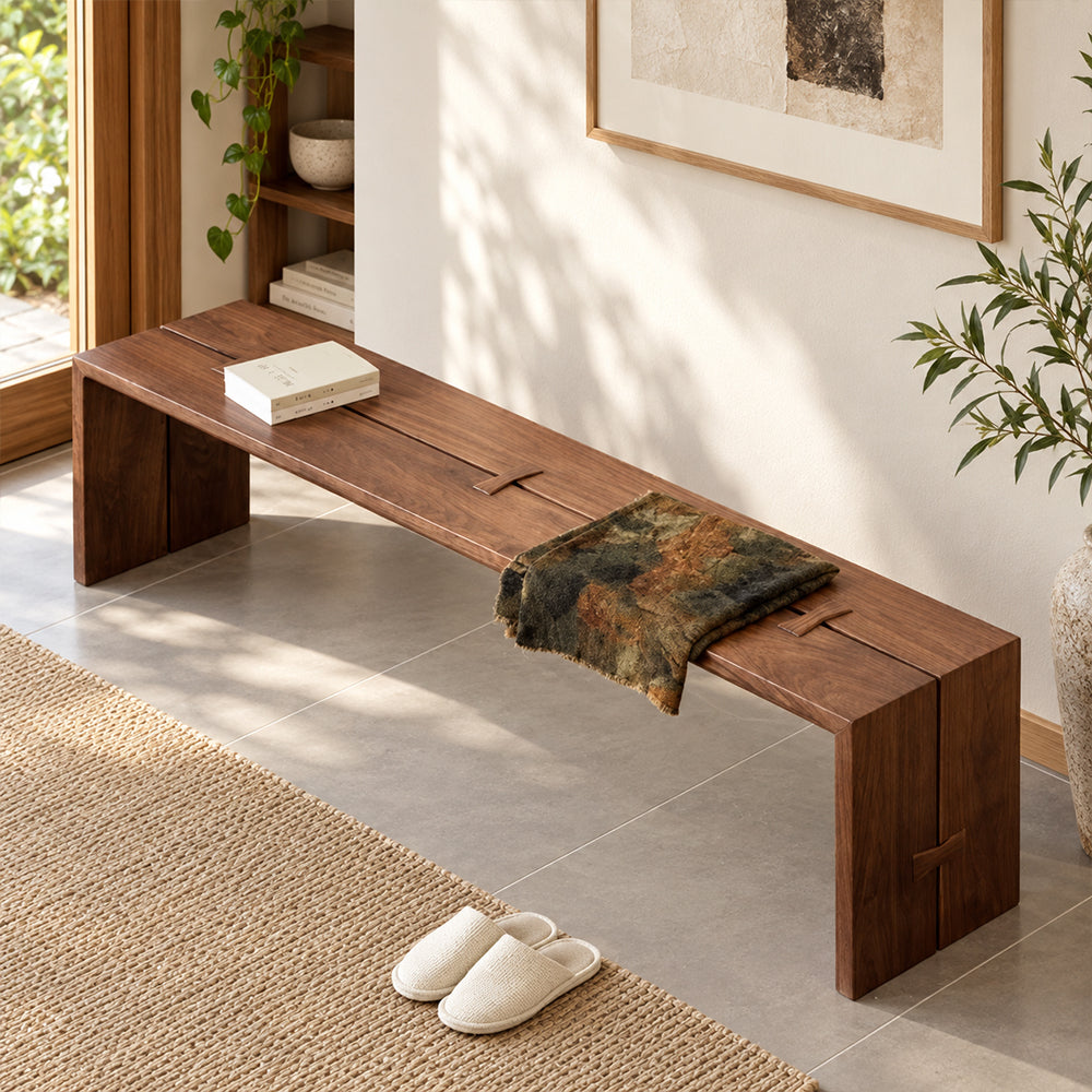 Overhead angled view of the brown bench's split seat surface and butterfly-shaped joint accents.