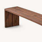 Angled detail of the brown bench top showing its long seam and butterfly-shaped joint accents.
