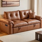 Brown sofa bed in sofa form with tufted seat and back cushions, rolled arms and front pull loops.