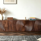 Front detail of the brown TV cabinet's large circular patterns and recessed base.