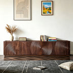 Brown TV cabinet with concentric circular patterns across its doors, styled with books and vases.