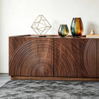 Close-up of the TV cabinet's concentric curved door grooves beneath colorful glass vases.