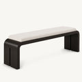 Long cream-cushioned bench with a black rounded frame and split slab side supports.