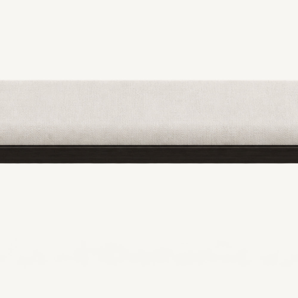 Front detail of the bench's cream upholstered cushion and black horizontal frame.