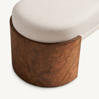 Overhead detail of the cream seat cushion wrapping into the rounded brown bench support.