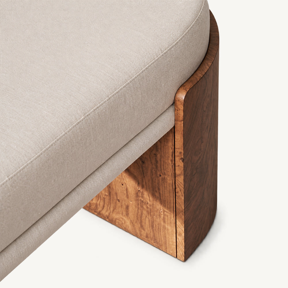Detail of the cream bench cushion and shaped brown support edge.