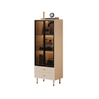 Tall narrow cream display cabinet with three glass display levels and fluted drawers on a white background.
