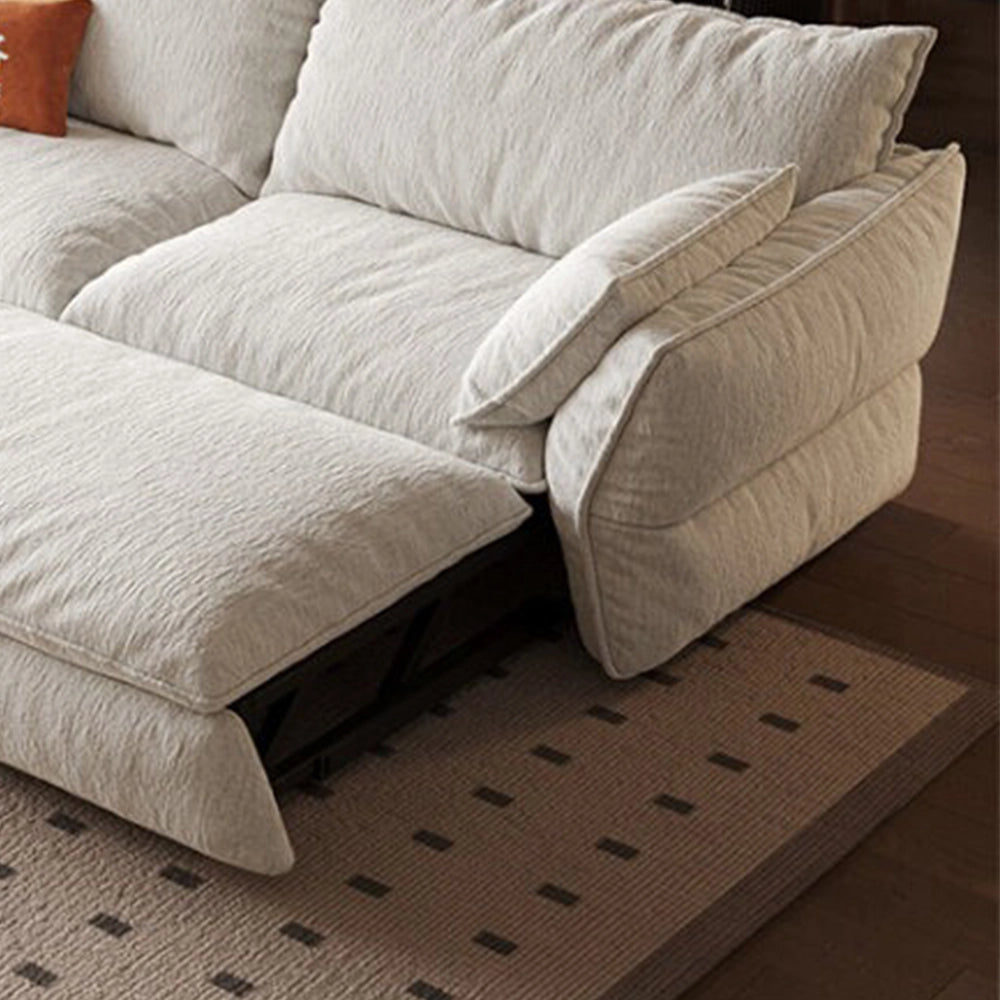 Close-up of the cream sofa bed's extended sleeping section, padded arm and exposed support frame.