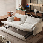 Cream sofa bed with its pull-out section raised, showing the folding support frame beneath the cushion.