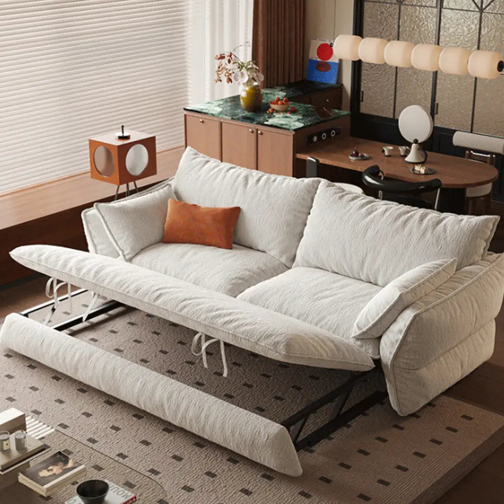 Cream sofa bed with its pull-out section raised, showing the folding support frame beneath the cushion.