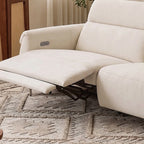 Close-up of an extended cream footrest, visible reclining mechanism and control panel inside the arm.