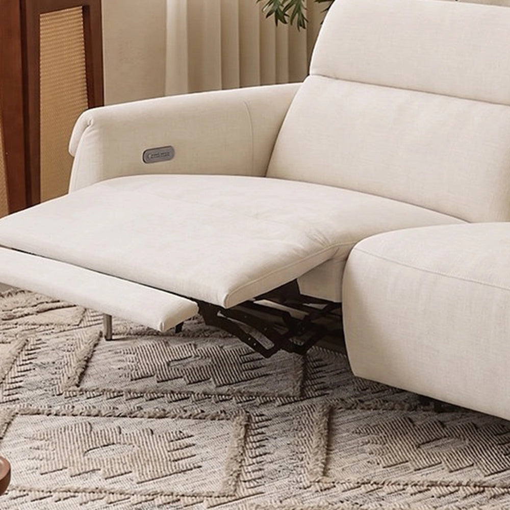 Close-up of an extended cream footrest, visible reclining mechanism and control panel inside the arm.