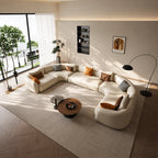 Cream U-shaped modular sofa with curved ends around coffee tables in a bright living room.