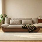 Front view of the brown-base sofa with taupe seat cushions and two lumbar pillows.