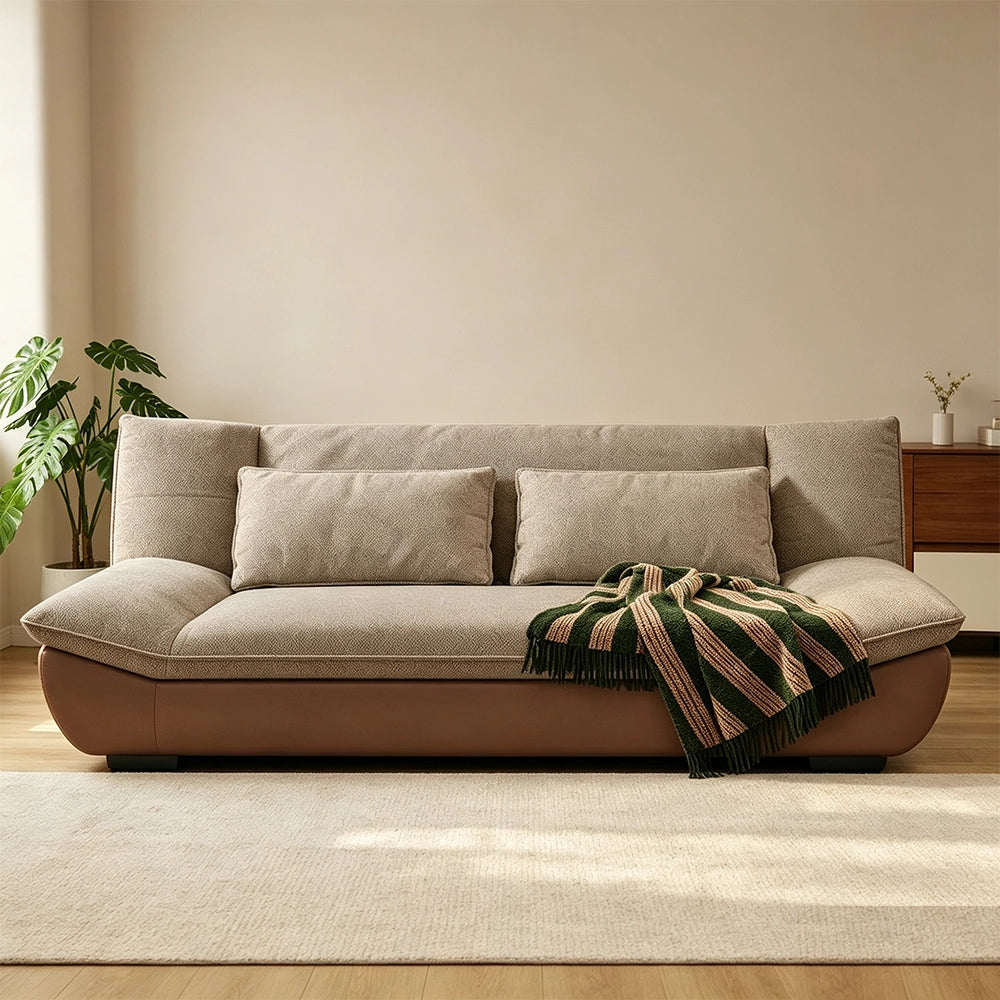 Front view of the brown-base sofa with taupe seat cushions and two lumbar pillows.