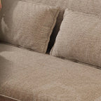 Close-up of the taupe sofa upholstery showing its woven surface texture.