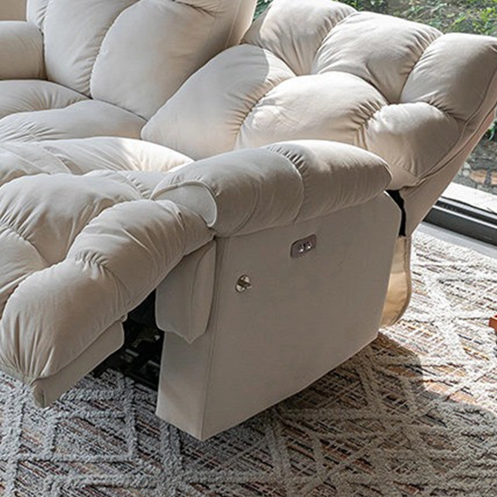 Close-up of the cream loveseat's padded arm, side control panel and reclining seat.