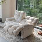 Cream reclining loveseat with one backrest lowered and one upright, showing deeply padded seat and arm cushions.