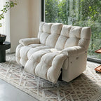 Cream deeply cushioned reclining loveseat in upright form on a patterned rug.