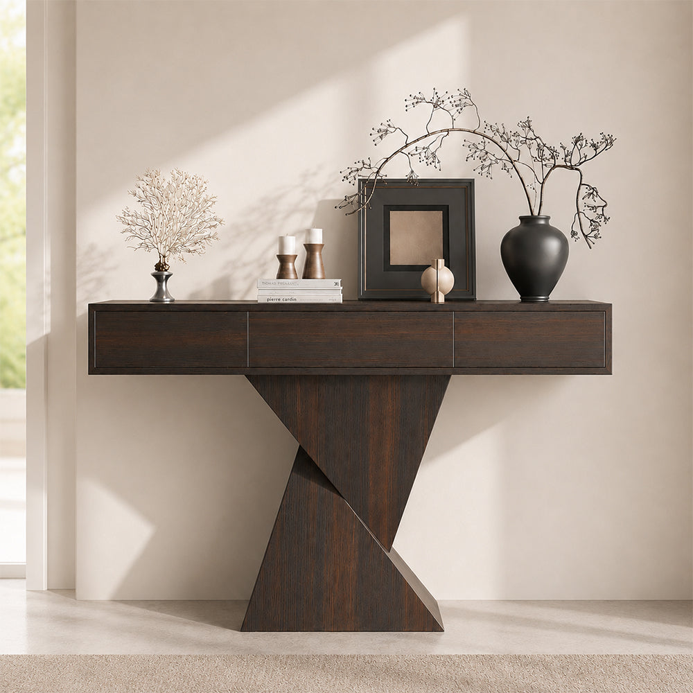 Front view of the three-drawer console table with a dark wood-tone geometric base.