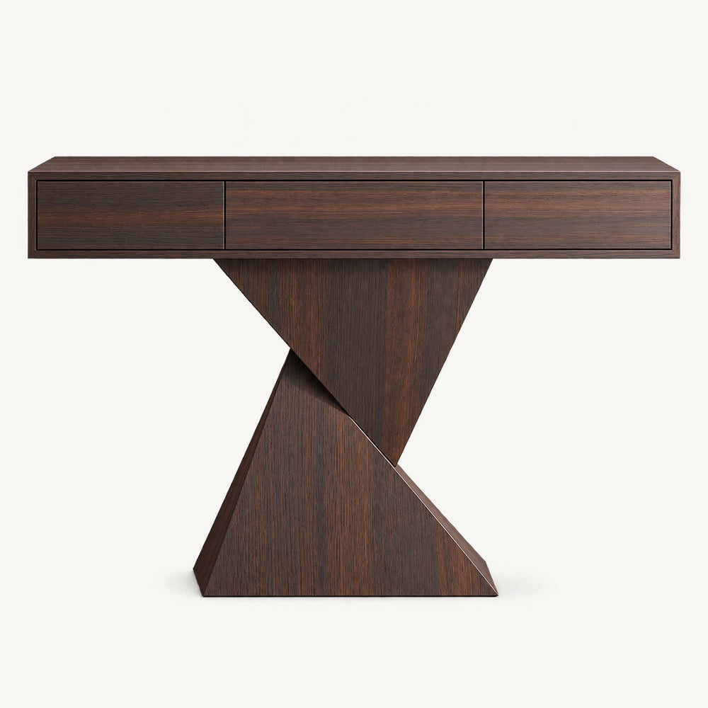 Dark wood-tone console table with three handleless drawer fronts above a geometric pedestal.