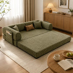 Green sofa bed unfolded into a flat sleeping surface with its front cushion extended onto the floor.