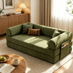 Opposite room view of the green sofa bed with rounded back and arm cushions.