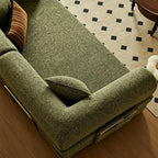 Overhead detail of the green sofa bed's seat cushion and rounded padded arm.