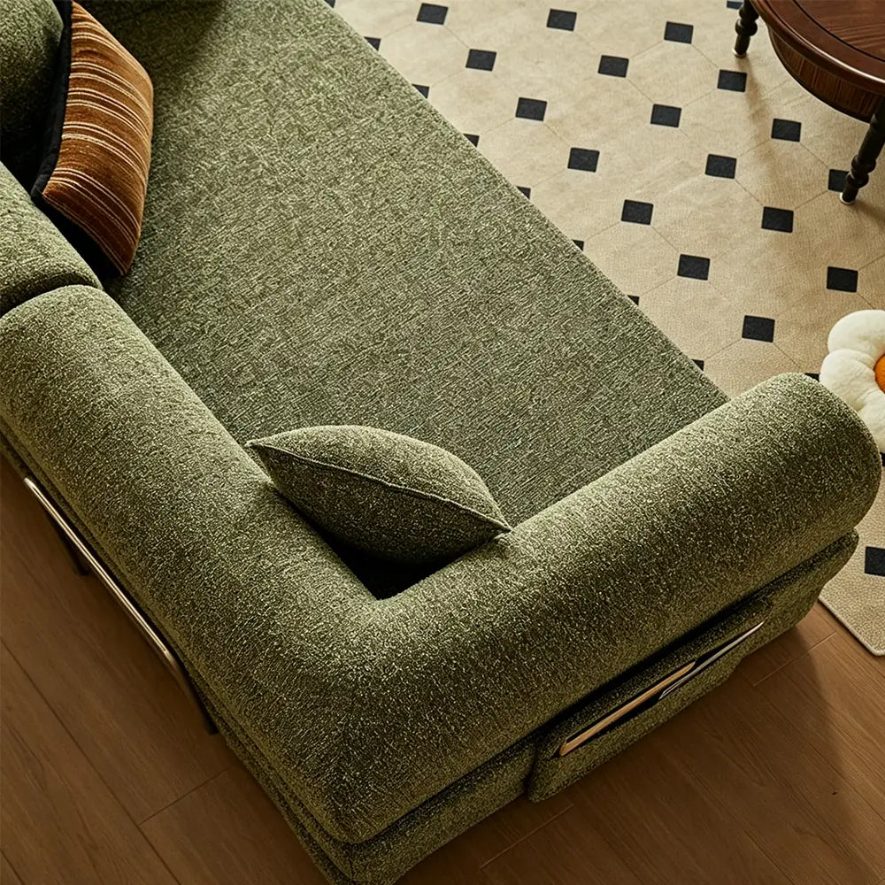 Overhead detail of the green sofa bed's seat cushion and rounded padded arm.