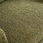 Close-up of the green sofa bed upholstery showing its woven texture.