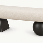 Front detail of the cream textured bench seat above its two black geometric supports.
