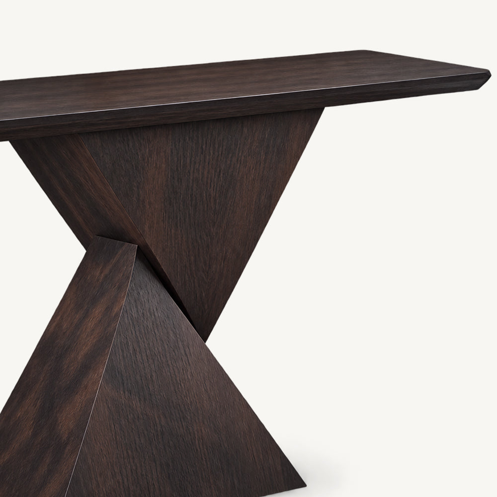 Close-up of the dark console table's top and angular pedestal.