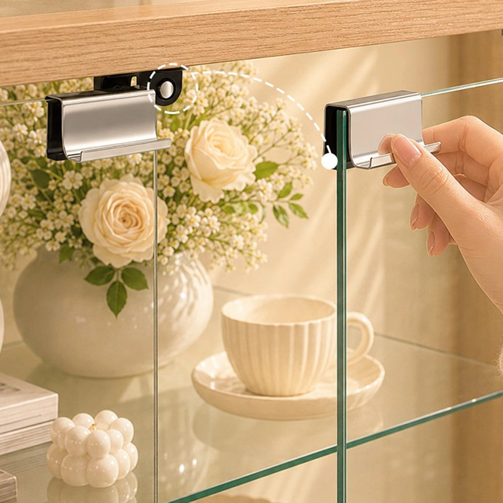 Hand opening a clear glass cabinet door using its rectangular metal handle.