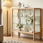 Opposite angled room view of the light wood-tone glass cabinet and its clear side panels.